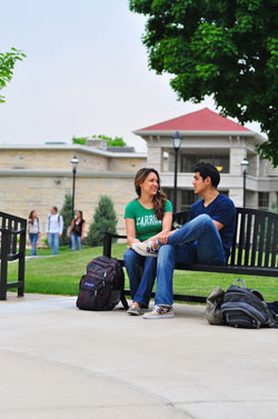 Image of students sitting outside the library