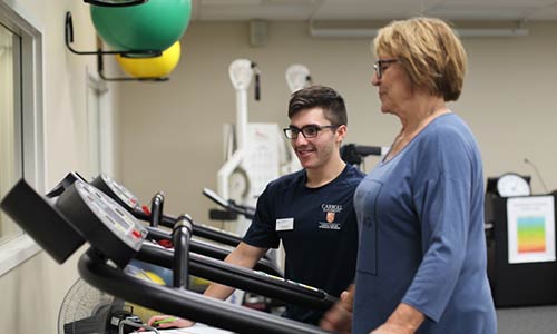 Student working with patient in cancer rehabilitation clinic
