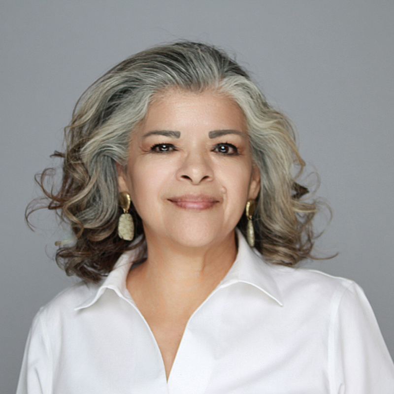 Women with gold earrings wearing a white blouse.