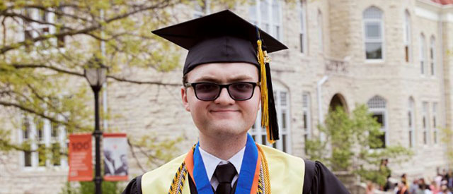 Anthony Sikorski celebrates Carroll degree by Main Hall