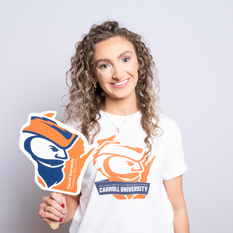 Women with curly hair wearing a Carroll University shirt,