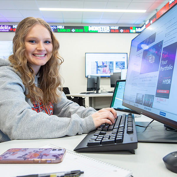 Finance student seated at a workstation