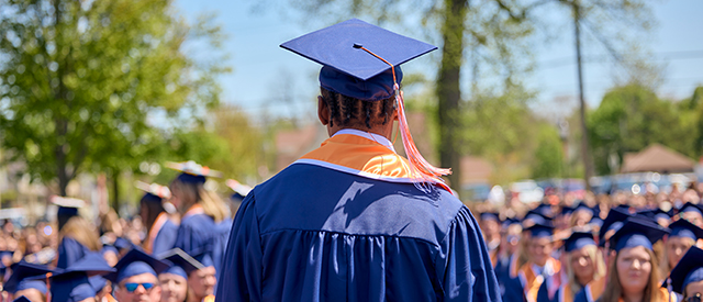 Student in graduation cap and gown.