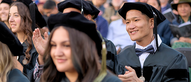 Graduate in cap and gown.