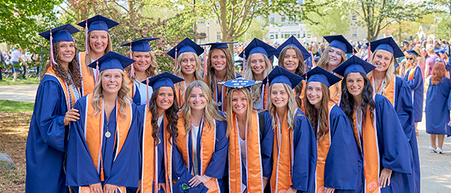 Group of girls in college graduation gowns.