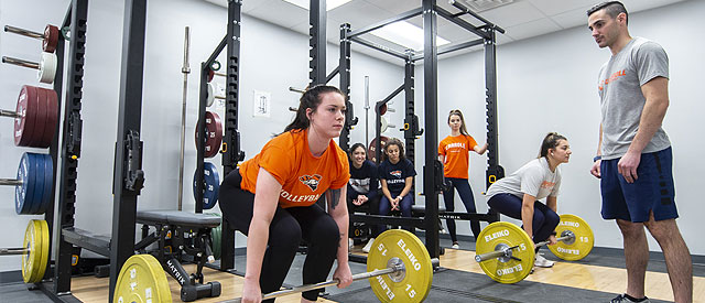 A female student weight lifting.