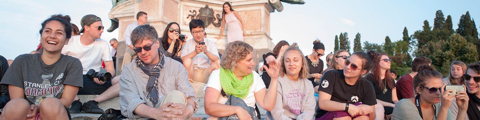 group of students sitting down in park