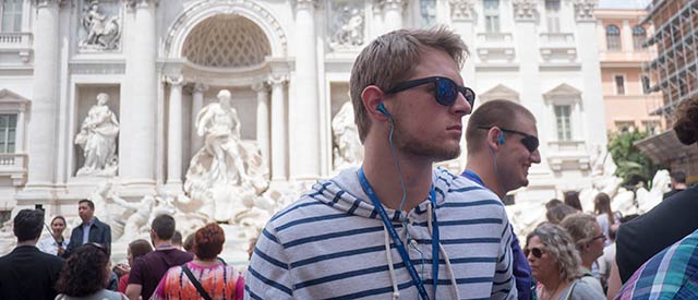 Male student in front of the Trevi fountain