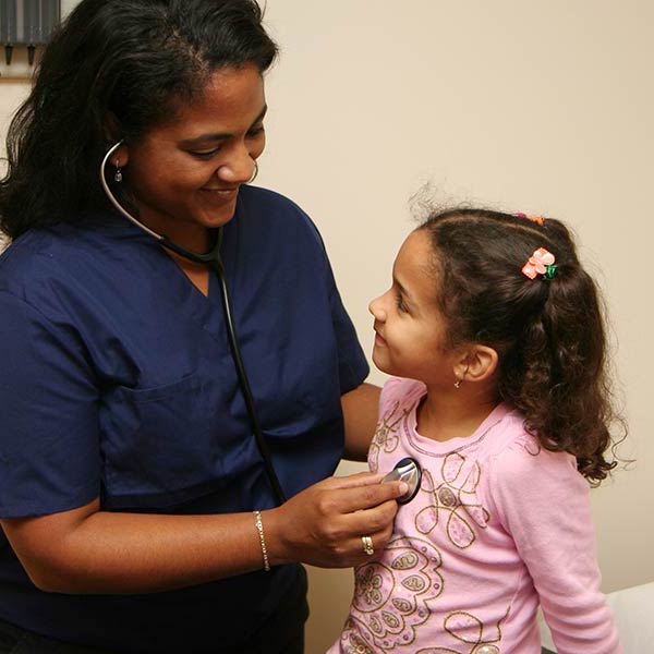 nurse working with a young patient