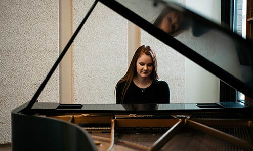 female student playing a piano