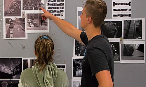 two students during a photography critique session