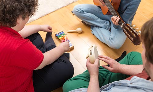 a music therapy session with three people