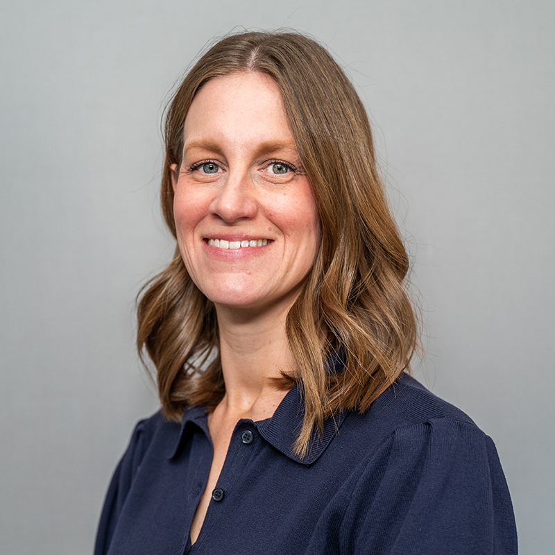 Women with blonde hair in a blue shirt.