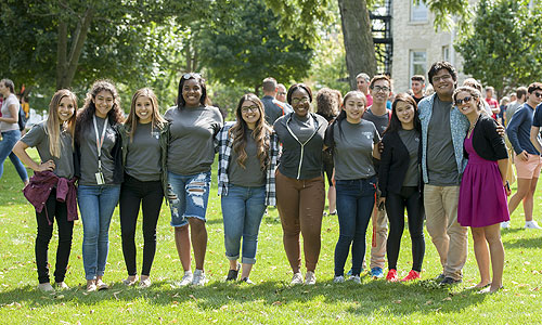 A diverse group of students smiling on campus
