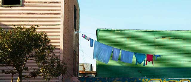 laundry hanging from a line in urban setting 