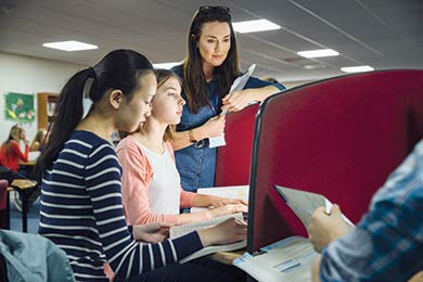 Teacher working with students