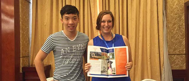 Duy Nguyen standing with Megan Couch, Carroll University International Student Coordinator