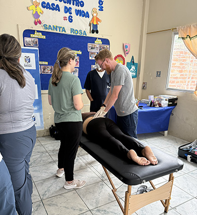 Carroll DPT student works on patient in Ecuador