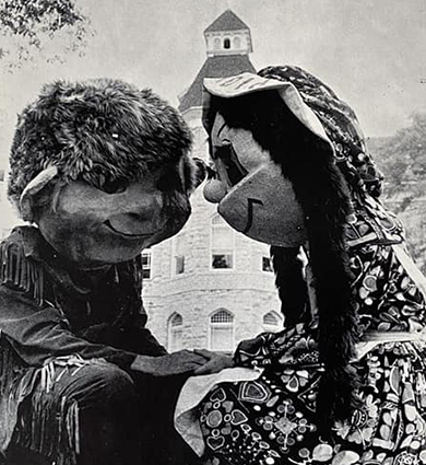 Pete and Polly holds hands in from of Main Hall at Carroll