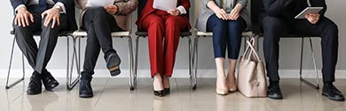 People in business attire waiting for an interview