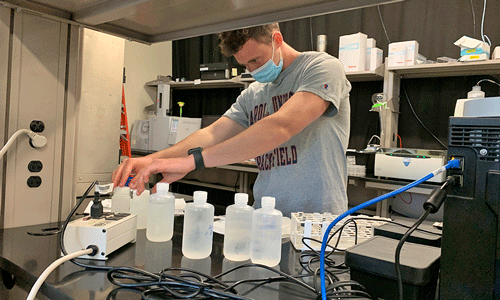 Carroll student performing analysis in chemistry lab
