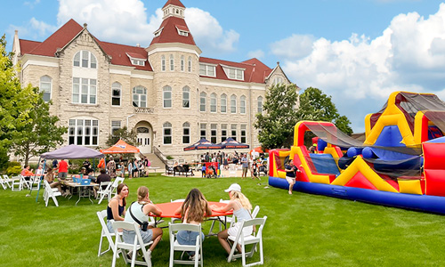 A photograph of a party on Main Lawn from the cover of the fall, 2022, issue of First magazine