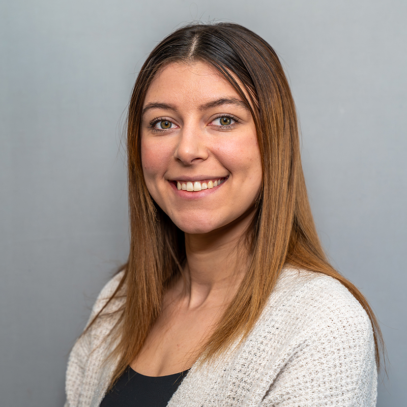 Women with brown hair wearing a sweater.