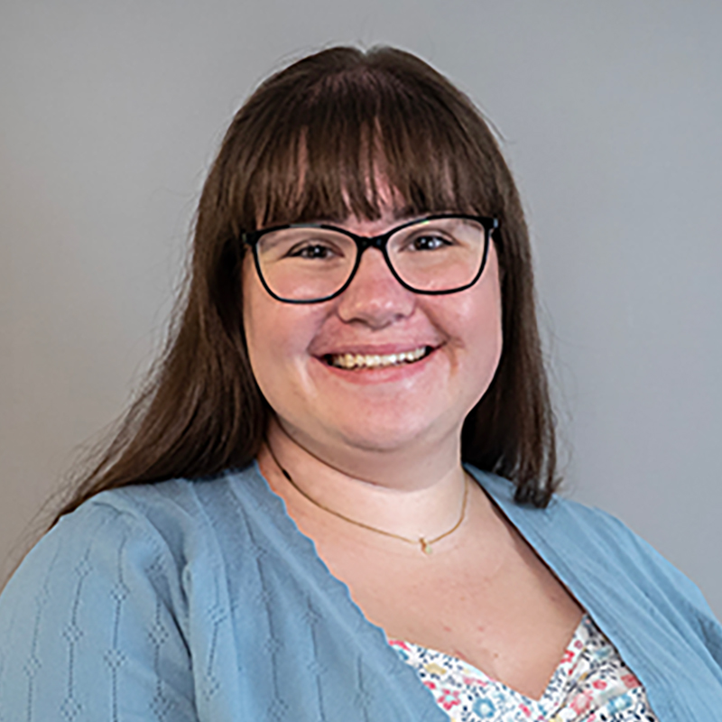 Women with glasses and blue blouse.
