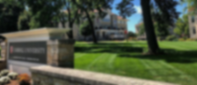 a blurred photo of the Carroll University sign and Main Lawn.