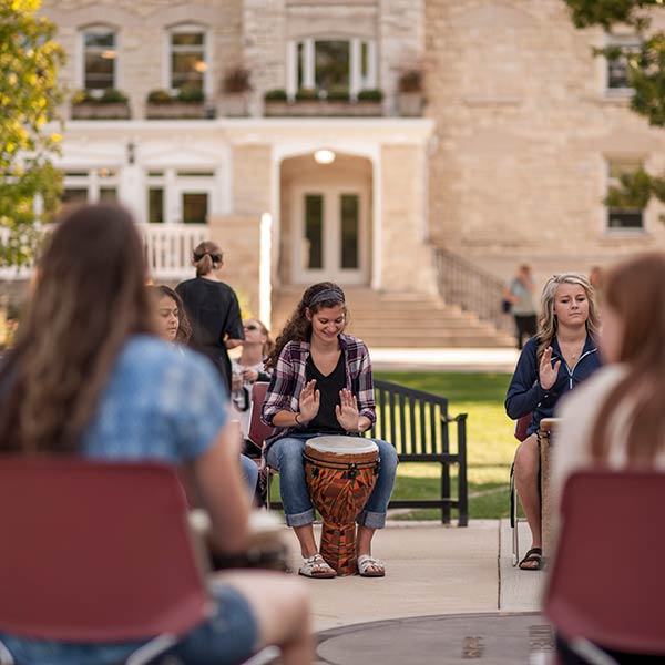 students playing instruments on main lawn 