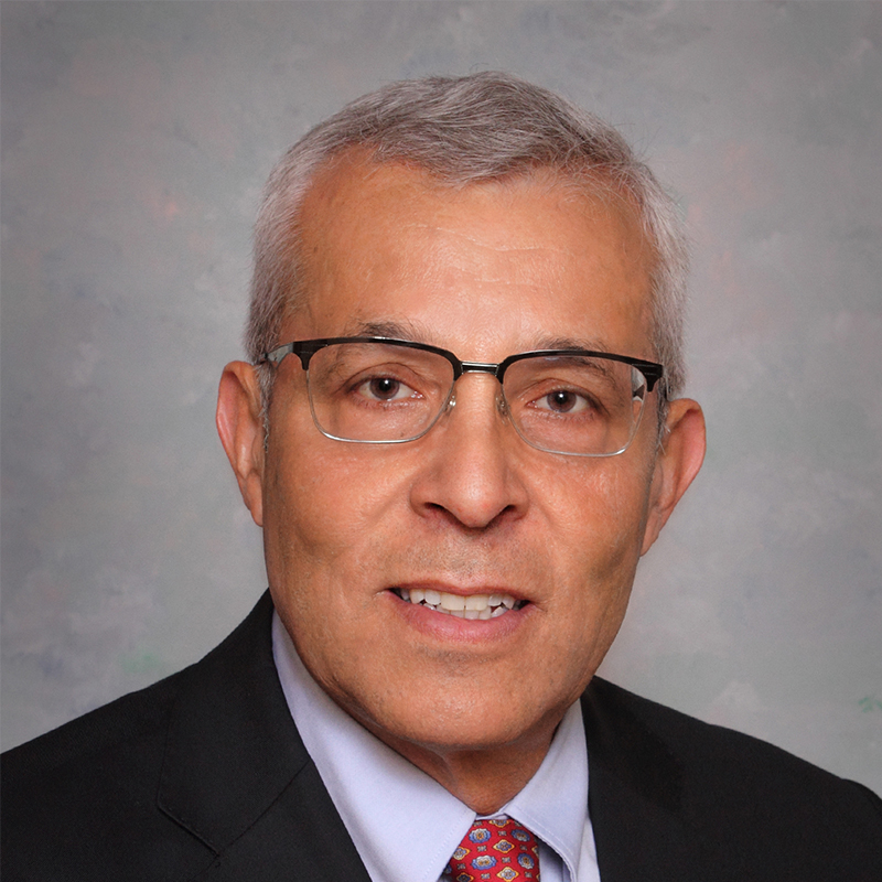 Man with glasses in a suit.