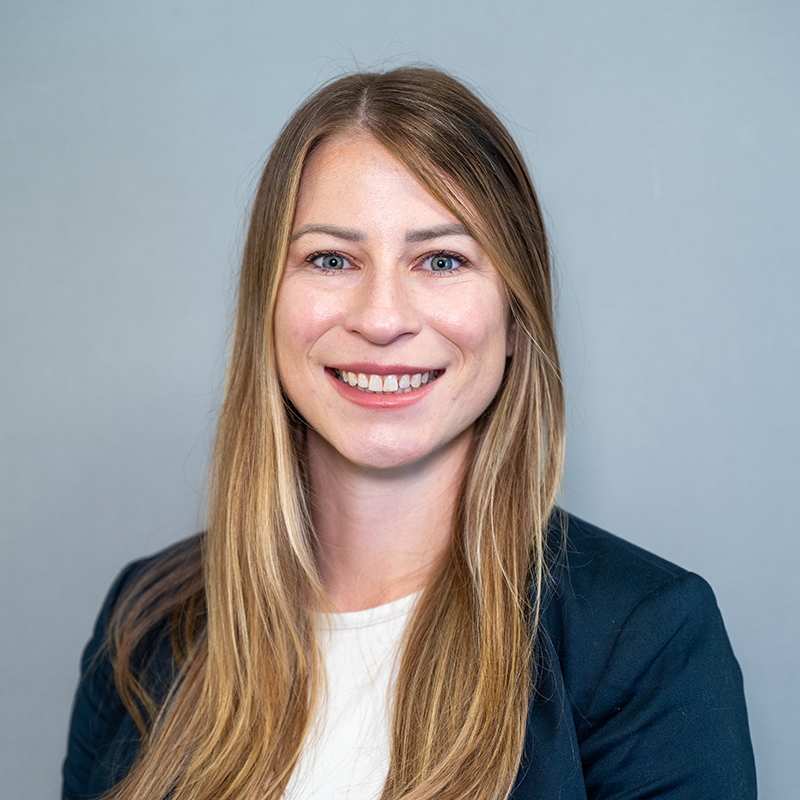 Women with long hair in blue blazer. 