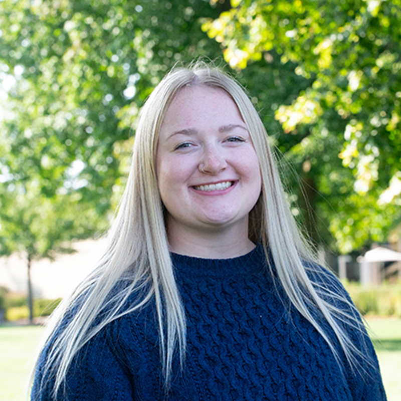 Women with blonde hair in a black sweater.