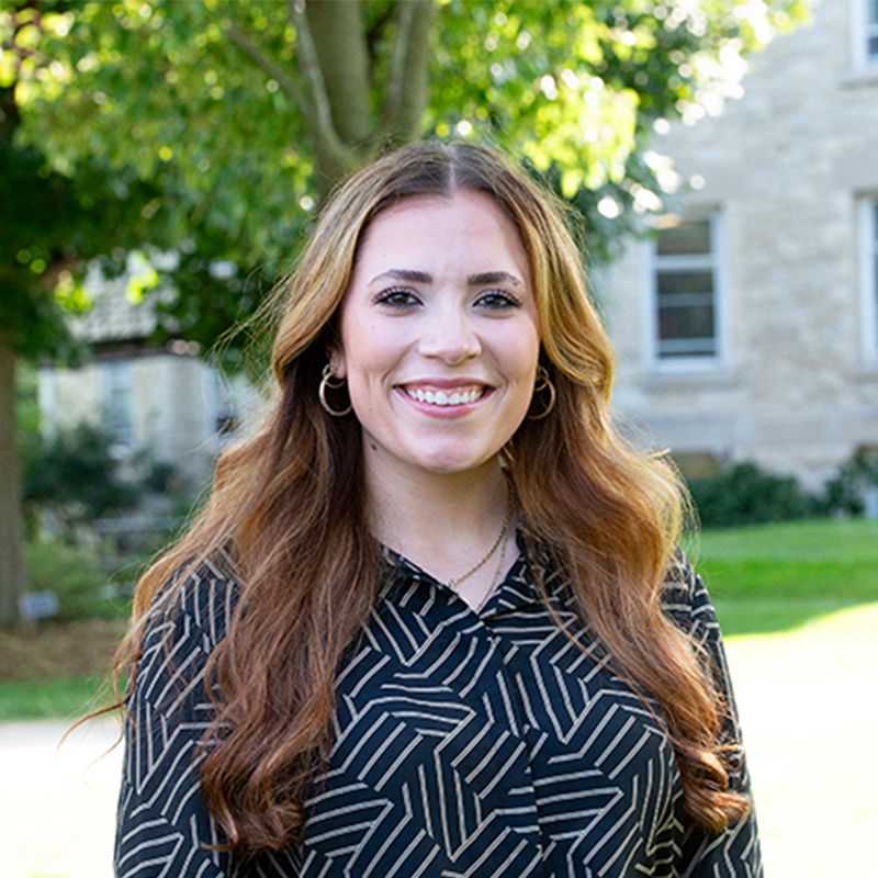 Women with long brown hair in a black shirt.