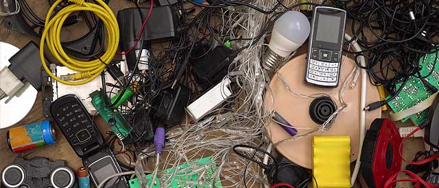 a table topped with electronics and wires.