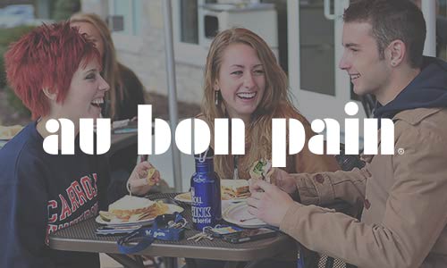 students eating with a au bon pain logo superimposed